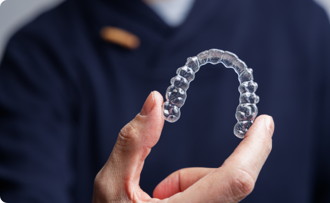 man-holding-one-transparent-aligner-invisalign-or-2023-11-27-05-25-25-utc
